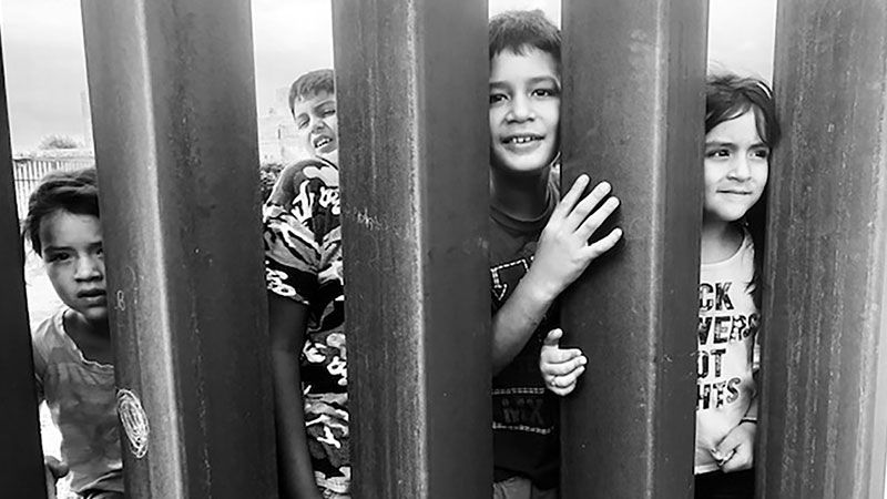 Photo of a group of children behind the wall