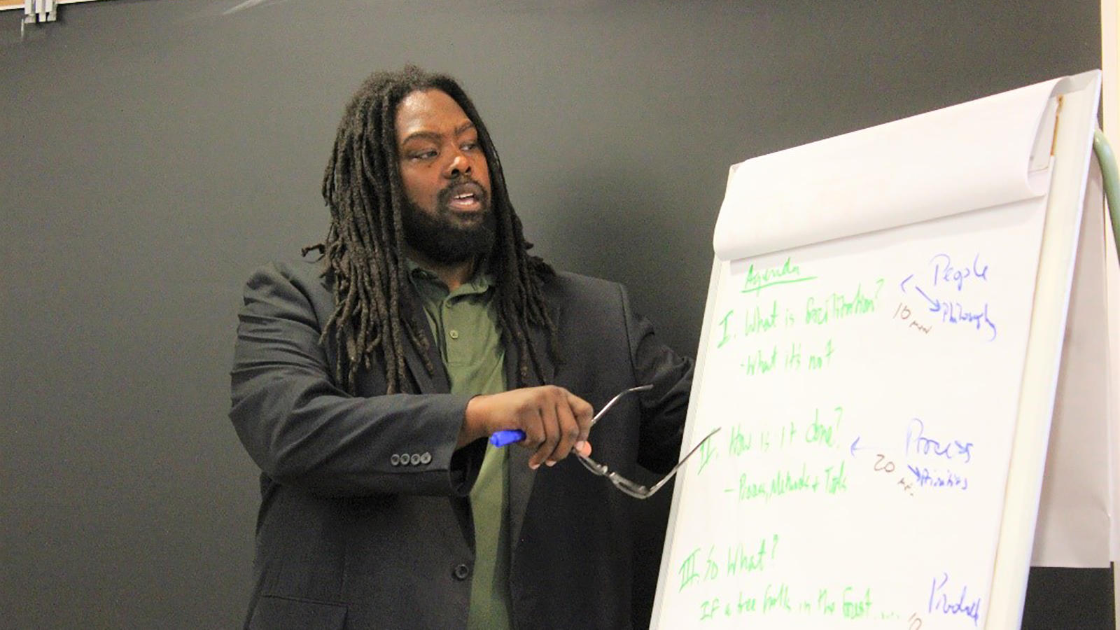  Social Justice Guest Speaker Everette W. Hill models the use of the flipchart as one of the many tools available for effective facilitation.