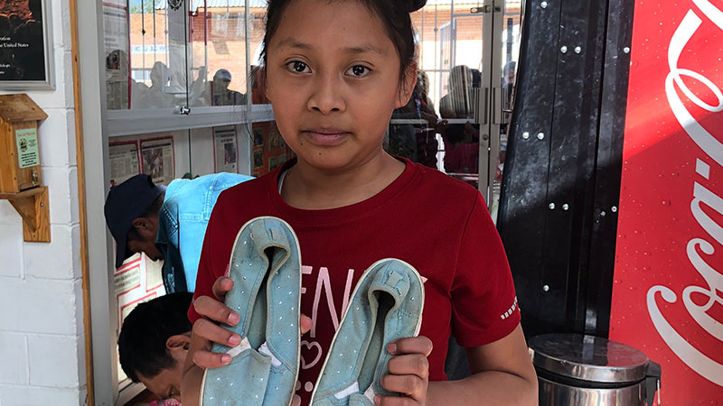 Photo of girl holding shoes
