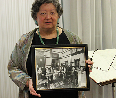 Chief Judge Armijo holds a photo of the final dramatic moments in a 1926 trial.