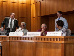 David Jenkins (standing) working with colleagues in the state capitol