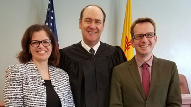 Abbey Ibrahim (Class of 2018) and Chris Pommier (Class of 2018) with the Honorable James O. Browning, U.S. District Judge, who generously helped prepare the team for competition.