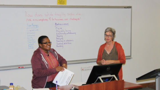 Photo of Monique Salhab (left) and Kendra Toth (right) introduce the topic of white supremacy in organizations