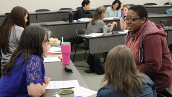 Monique Salhab (right) engages audience members during the small group discussions