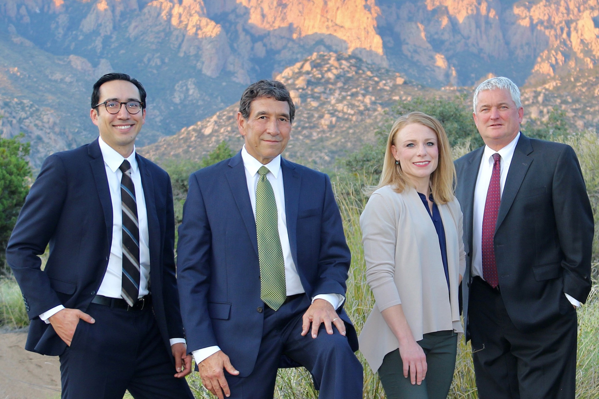 the 4 partners of Martinez, Hart, Sanchez & Romero, standing in front of the sandia mountains