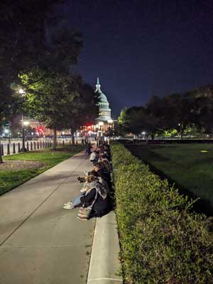 Students sitting on the sidewalk in Washington DC